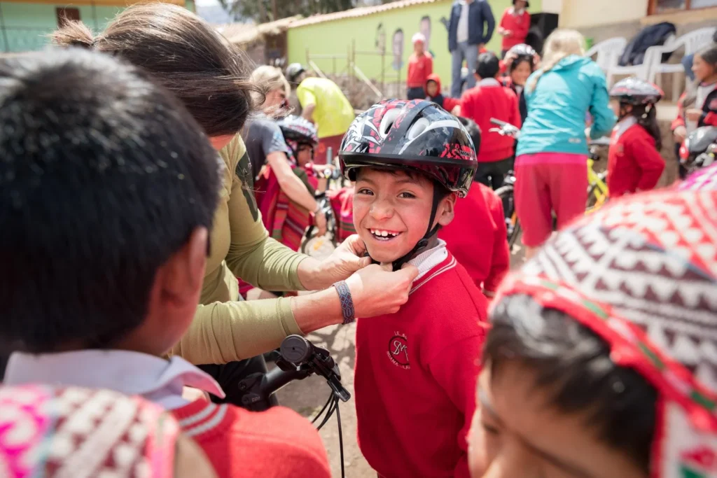 Children wearing biking helmet in Peru