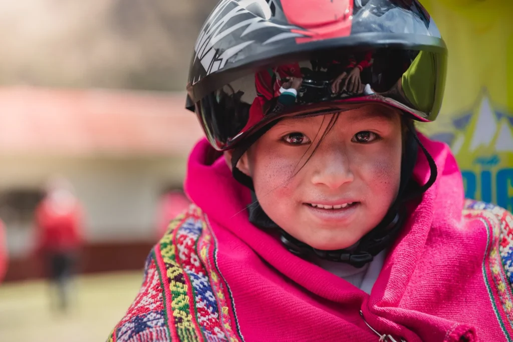 Child wearing biking helmet in Peru