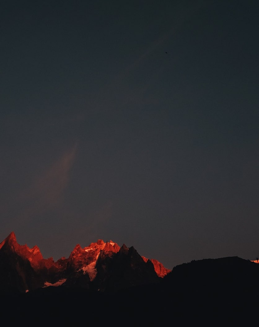 Sunset casting a red tint over the mountains