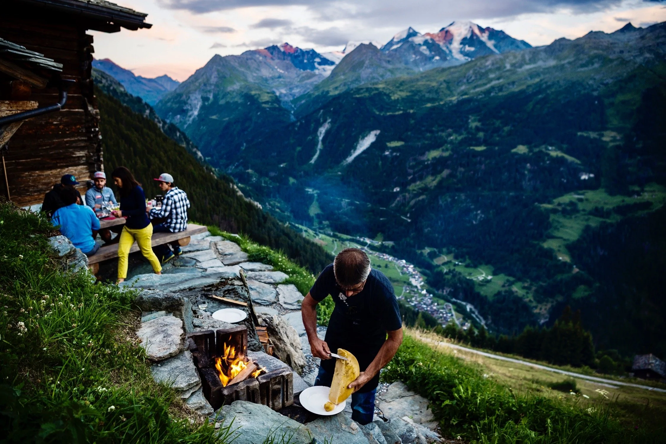 Jean-Marc with a wheel of local Bagnard cheese at his mayen high above their hotel in the village of Lourtier.