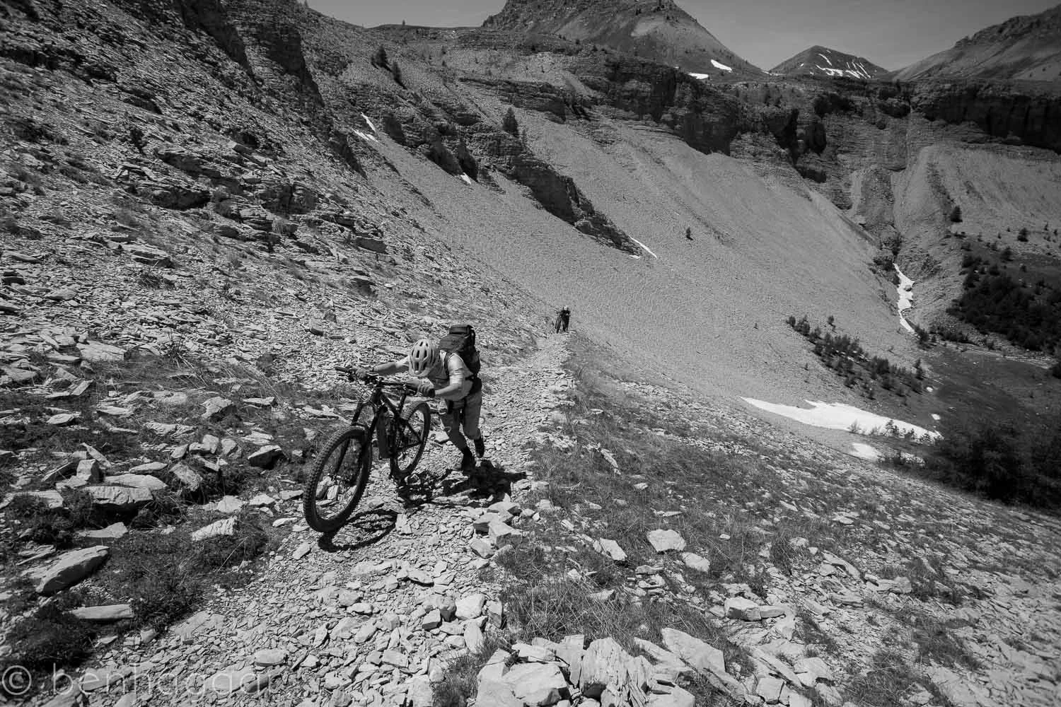 Hiking uphill mountain with a bike