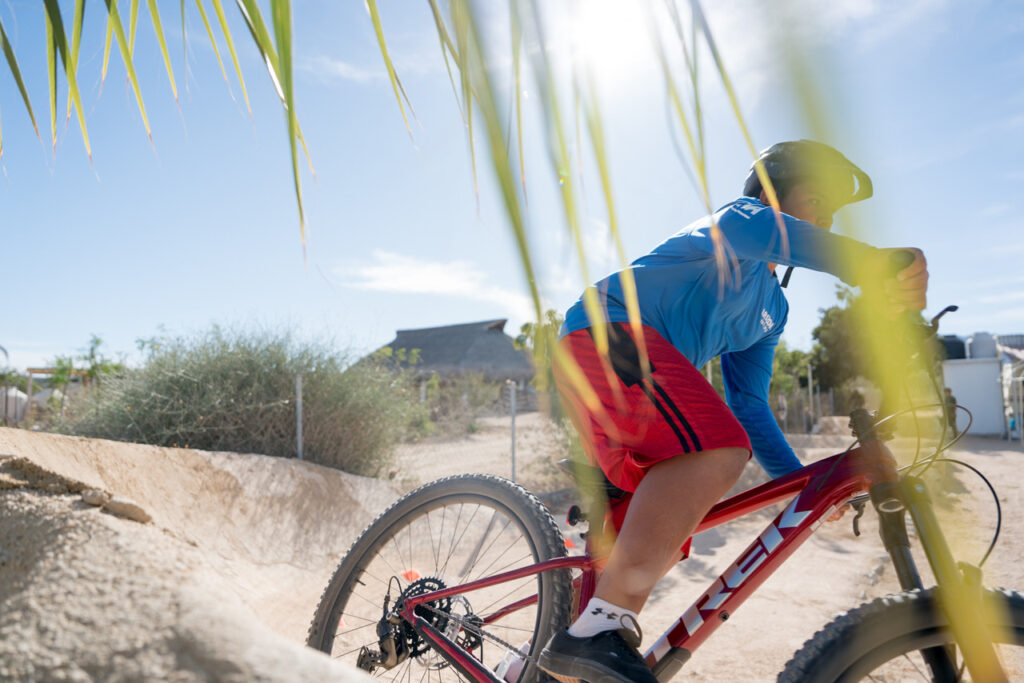 Youth rides Trek mountain bike.