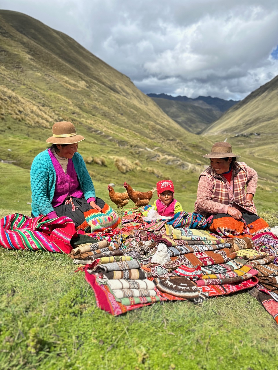 Peruvian women and toddler with handmade textiles.