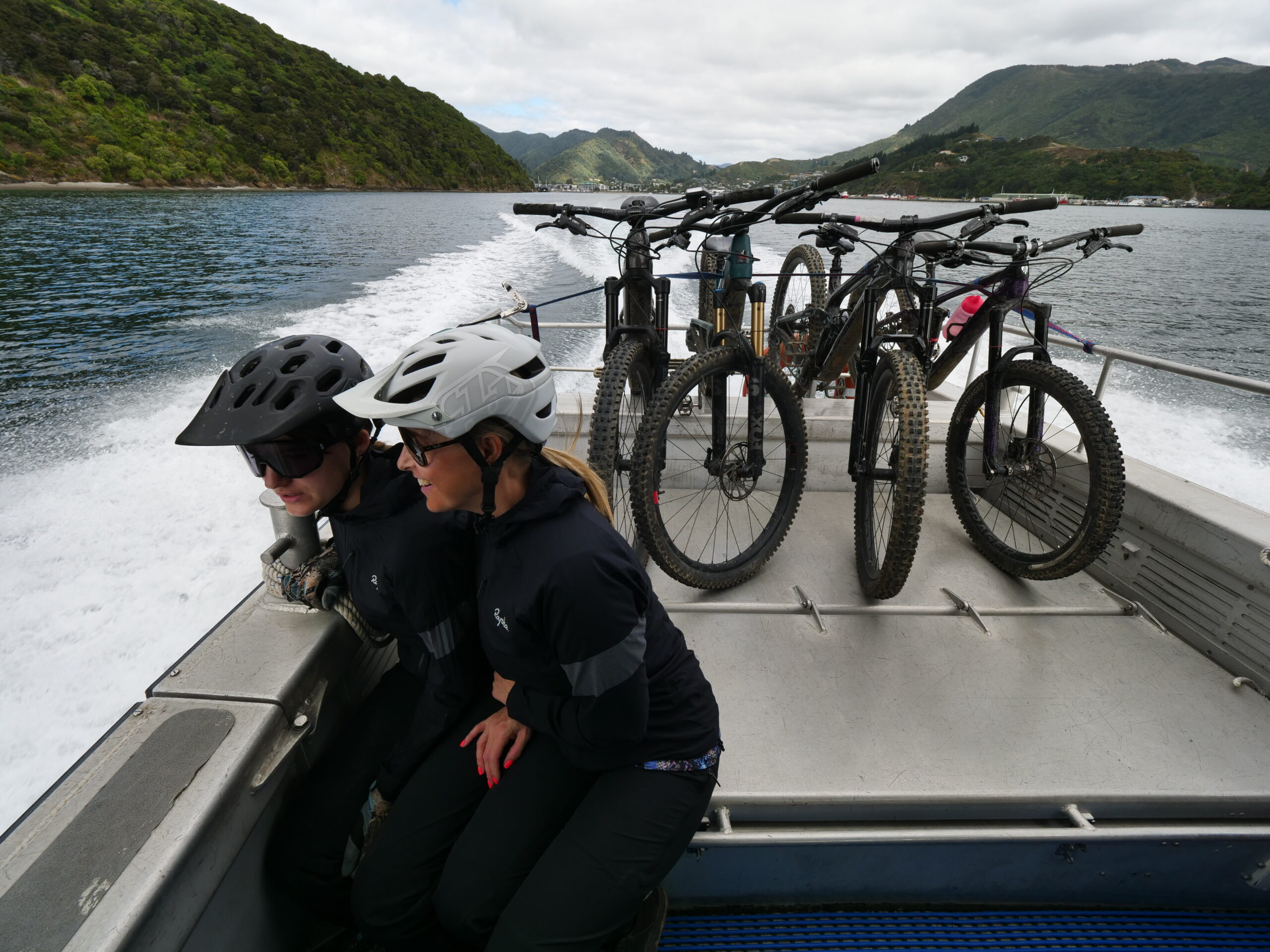 Mom and daughter on boat in NZ with mtn bikes